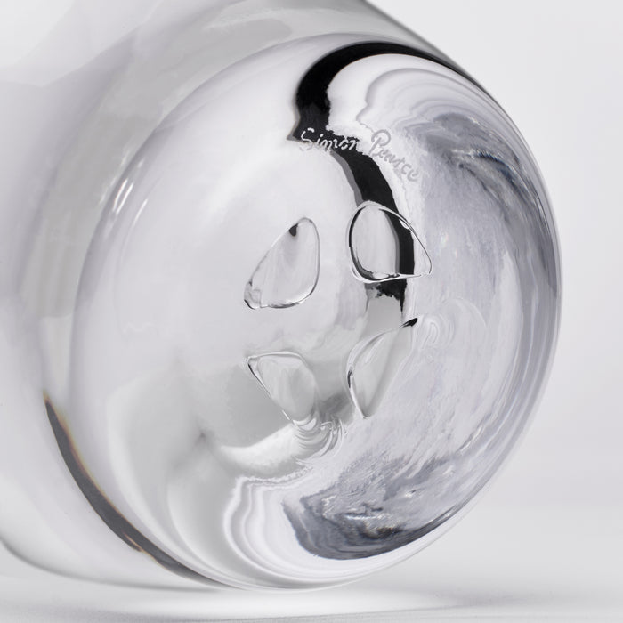 Clear glass decanter with black swirl pattern and maker's mark on rounded body.