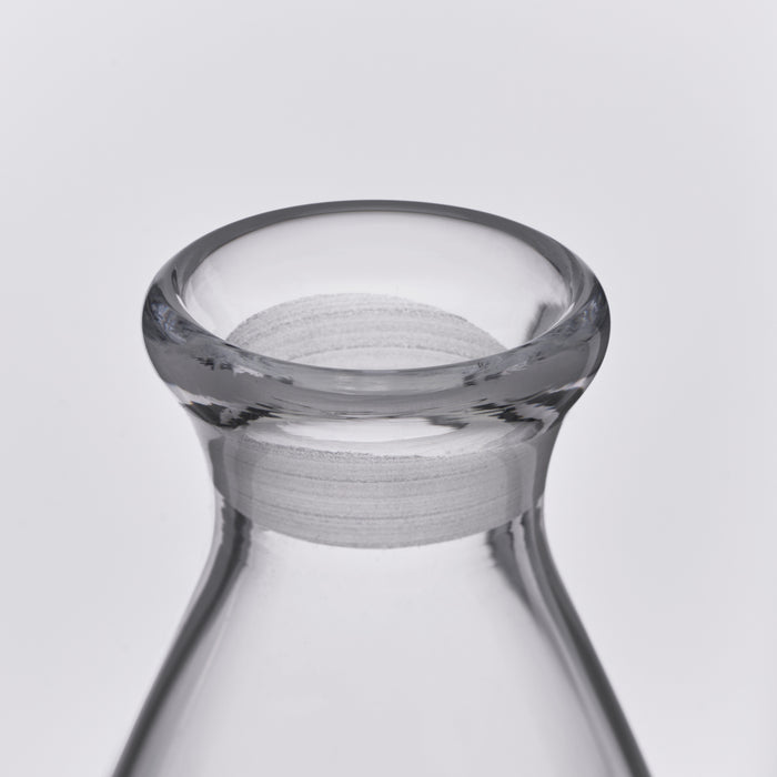 Clear glass decanter with a wide flared rim and gray fabric collar band around the neck.