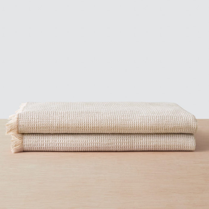 Stack of two waffle weave bath towels, tan