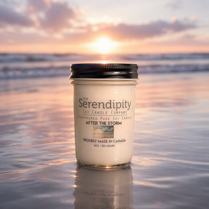 Serendipity candle in the water with a sunset background