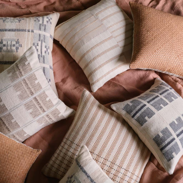 Overhead of various geometric pillows, stone-blue