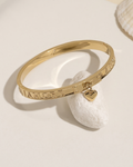 Gold bangle bracelet, flat lay