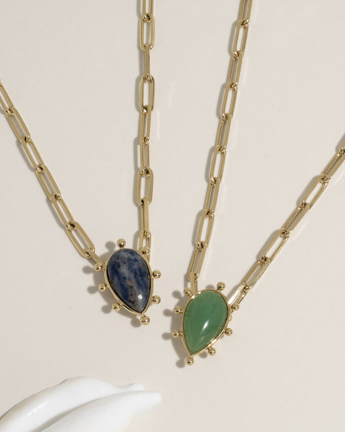 Gold paperclip chain necklace with teardrop green gemstone pendant and gold ball accents