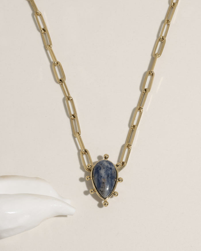 Gold paperclip chain necklace with teardrop green gemstone pendant and gold ball accents