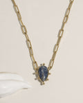 Gold paperclip chain necklace with teardrop green gemstone pendant and gold ball accents