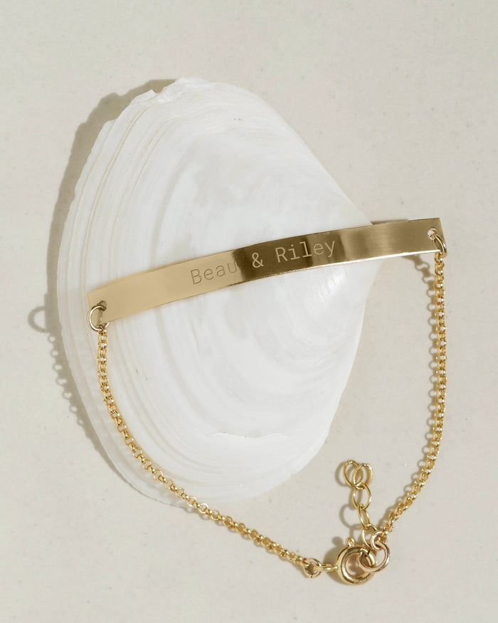 Gold signet ring with mother-of-pearl initial disc, product photo