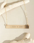 Gold horizontal bar necklace with custom engraved text