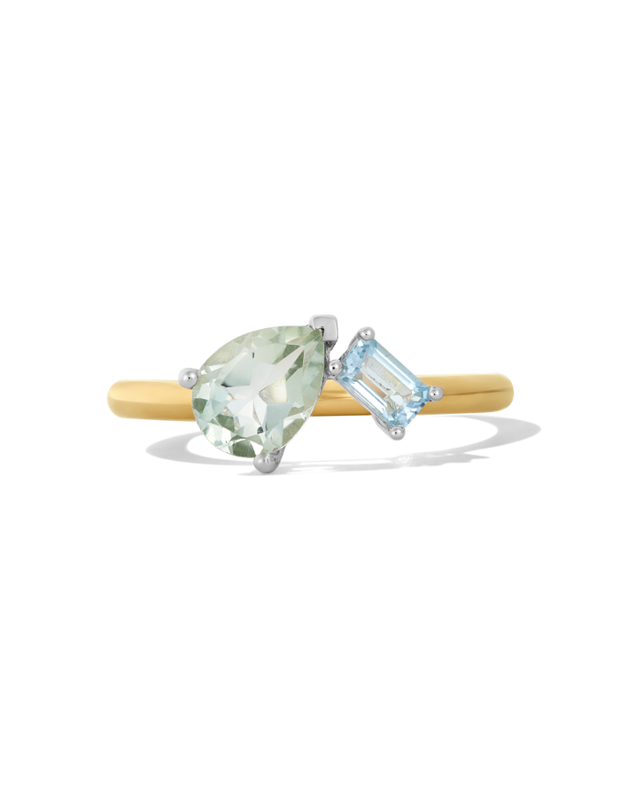 Gold band ring featuring a pear-shaped green stone and square blue topaz stone in silver prong settings