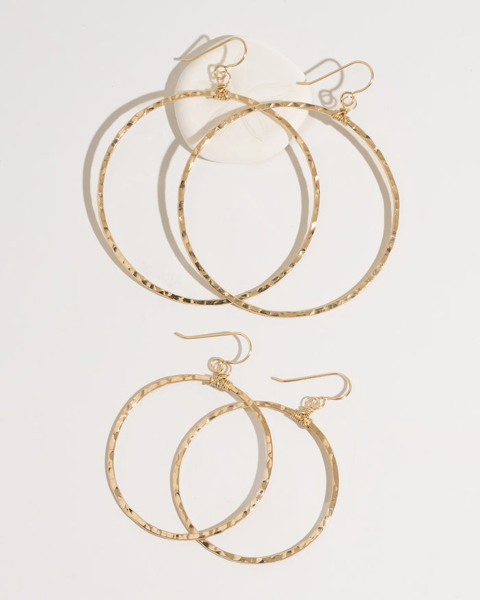 Gold bohemian hoop earrings both sizes displayed together on surface