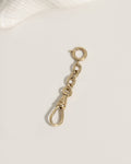 Gold bracelet with a small charm