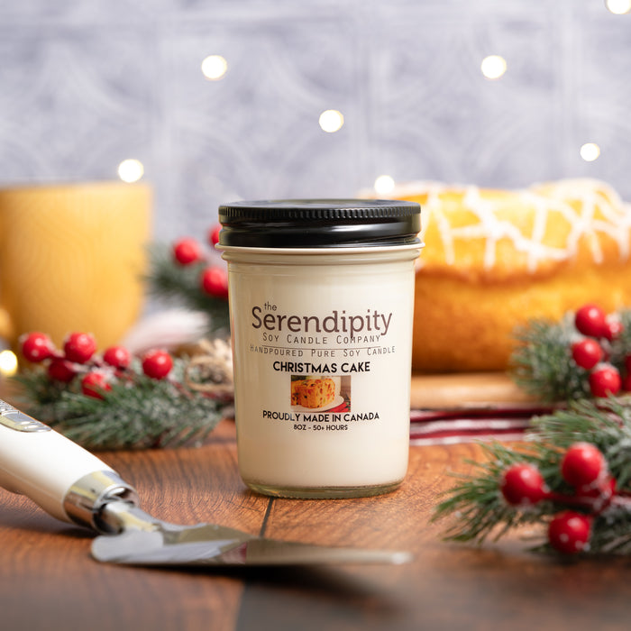Serendipity "Christmas Cake" candle, surrounded by Christmas decorations