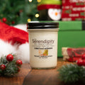 Serendipity Christmas Morning candle with Christmas-themed packaging and decorations in the background