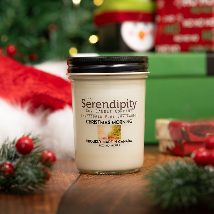 Serendipity Christmas Morning candle with Christmas-themed packaging and decorations in the background