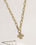 Gold necklace with pendant, flat lay