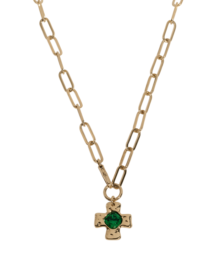 Gold necklace with a small dark gemstone pendant
