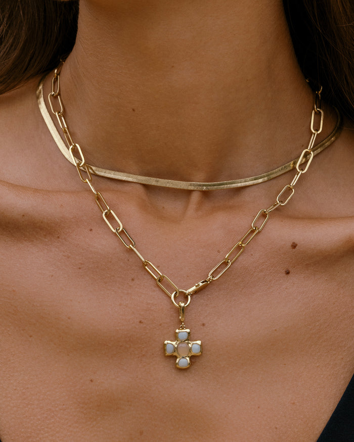 Close-up of a woman wearing layered necklaces