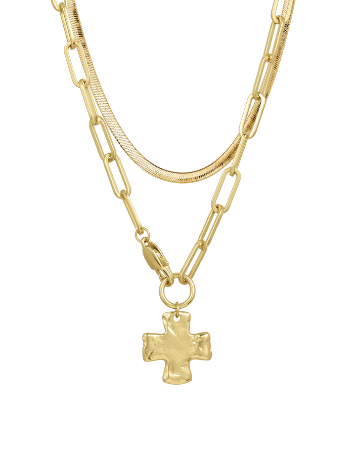 Layered gold necklaces with a cross pendant