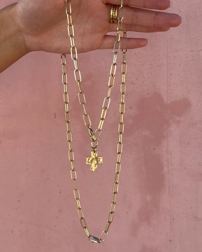 Close-up of a woman wearing layered necklaces