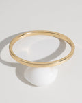 Classic gold bangle bracelet lifestyle product photo on surface