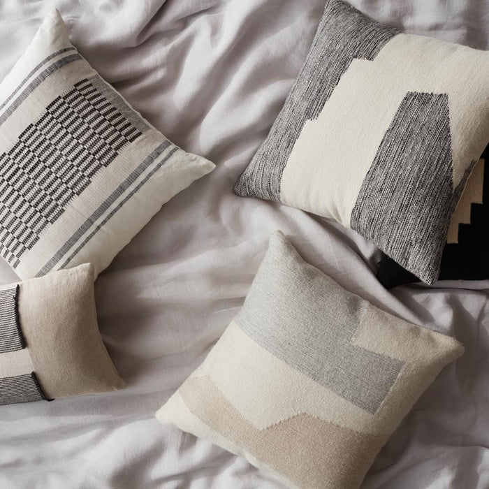 Neutral Modern Decorative Pillow styled with throws on bed, black and cream