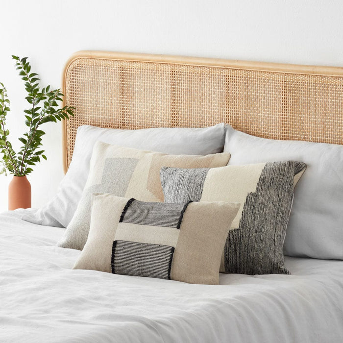 Neutral Modern Decorative Pillow styled on bed, black and cream