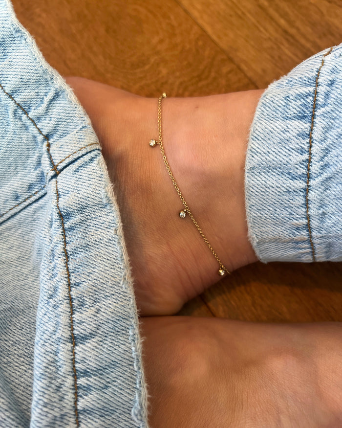Delicate gold anklet with bezel-set crystal charm accent