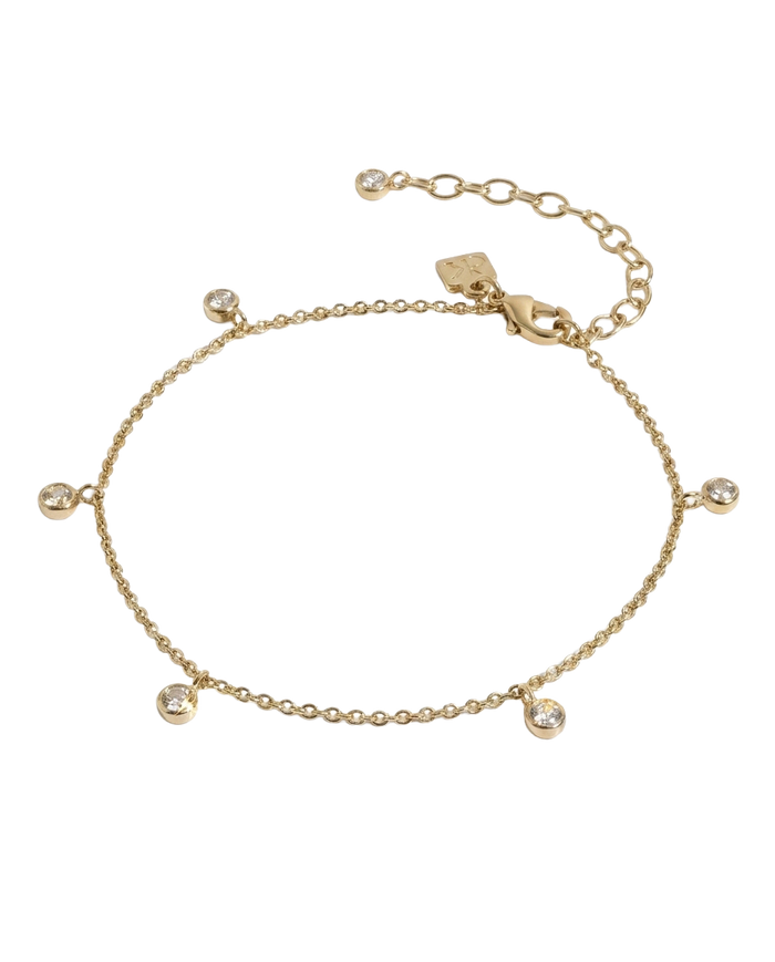 Delicate gold anklet with bezel-set crystal charm accent