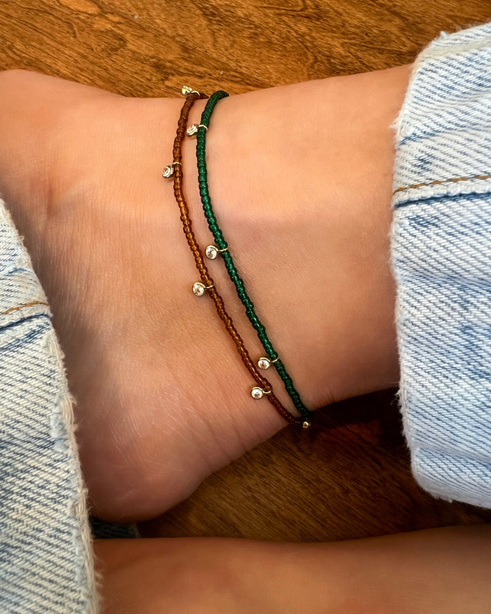 Beaded anklet with mixed crystal and gold bead accents on elastic cord