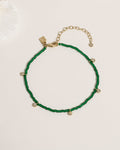Beaded anklet with mixed crystal and gold bead accents on elastic cord