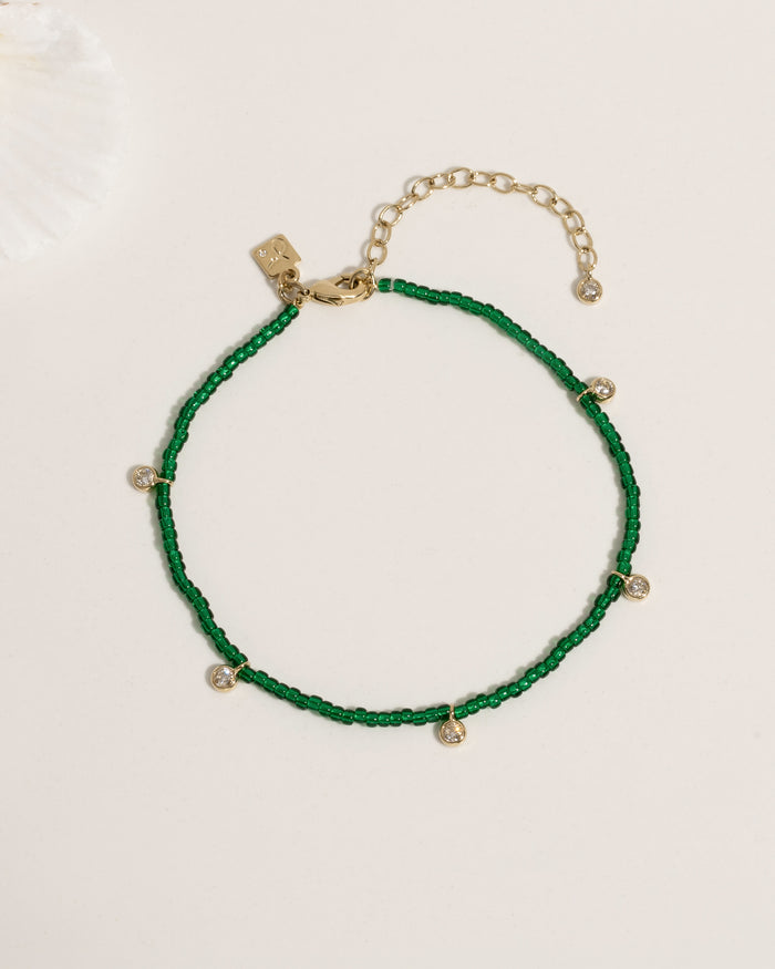 Beaded anklet with mixed crystal and gold bead accents on elastic cord