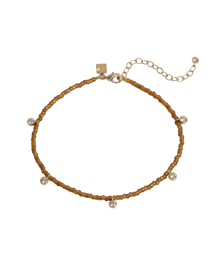 Beaded anklet with mixed crystal and gold bead accents on elastic cord