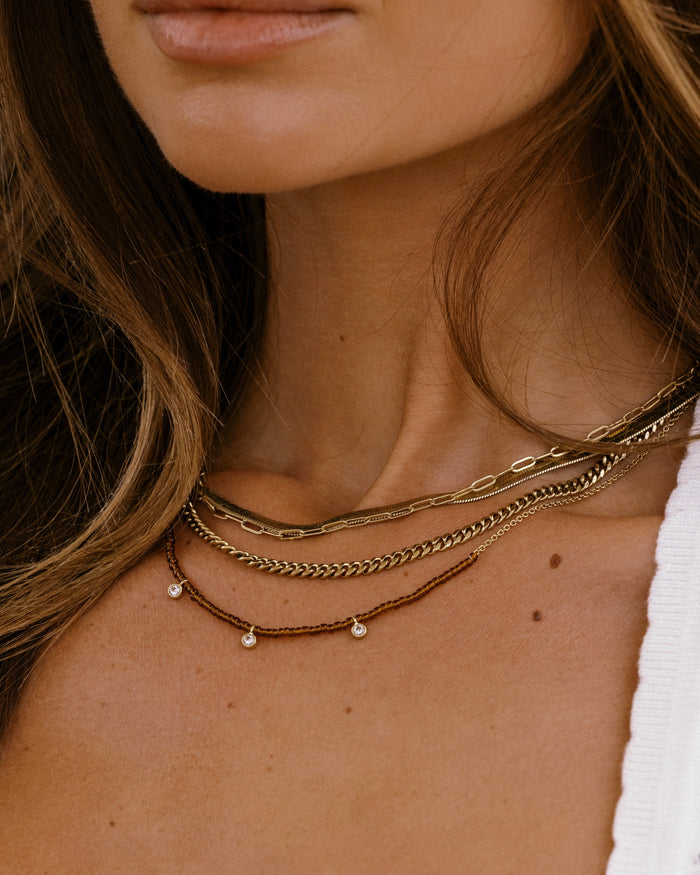 Beaded necklace with mixed crystal and gold bead accents, detail view
