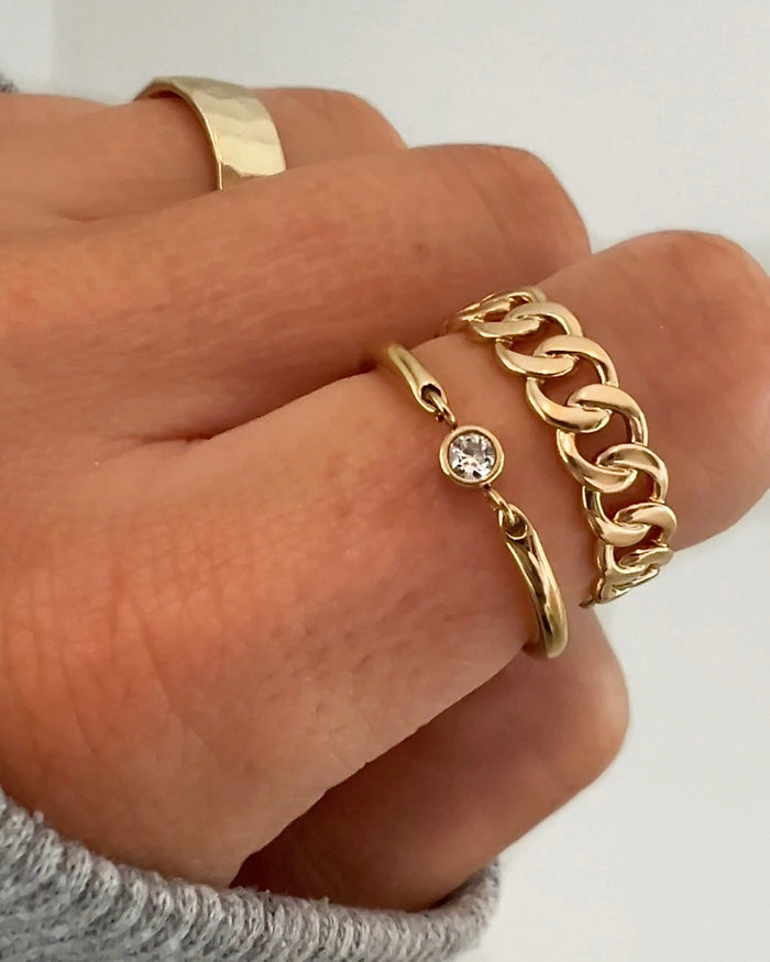 Hand wearing stacked gold rings