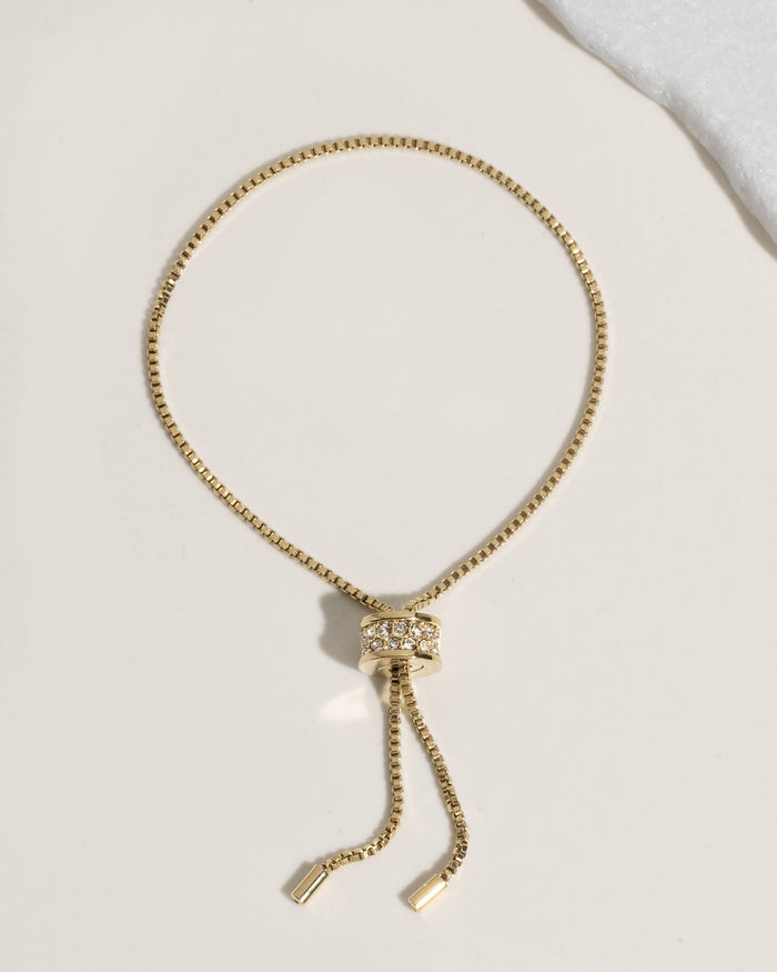 Gold adjustable bolo bracelet with crystal-encrusted sliding clasp on box chain