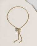 Gold adjustable bolo bracelet with crystal-encrusted sliding clasp on box chain