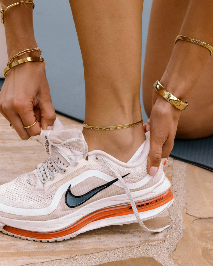 Two-layer gold anklet set combining flat herringbone chain and paperclip link chain