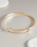 Gold bangle bracelet with bar and hardware clasp detail