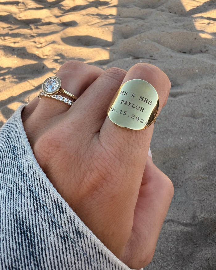 Model wearing gold personalized engraved ring