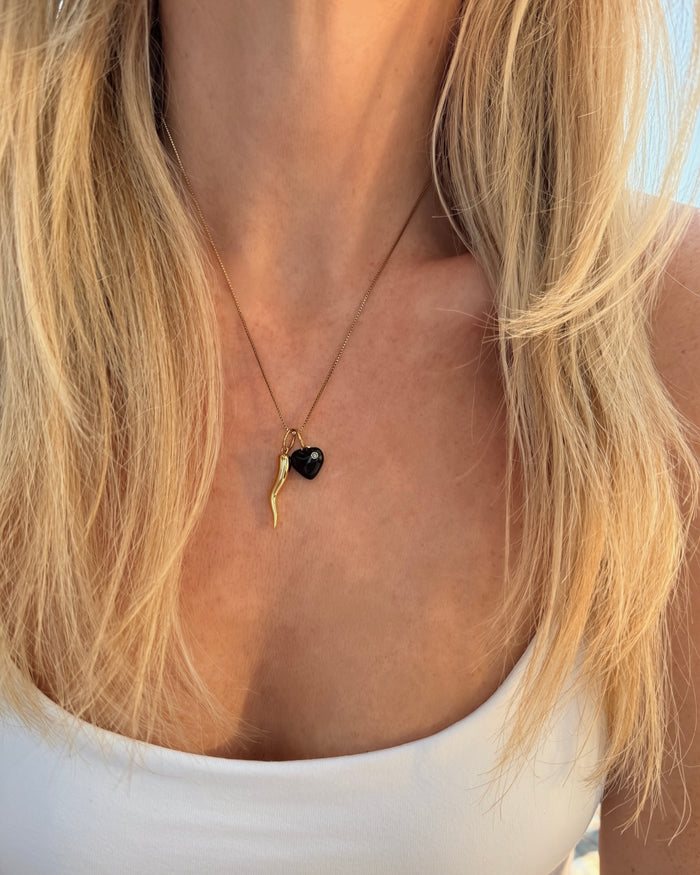Close-up of a gold necklace on a model's chest