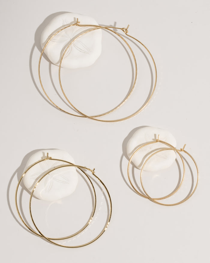 Gold hoop earrings collection display showing all styles and sizes