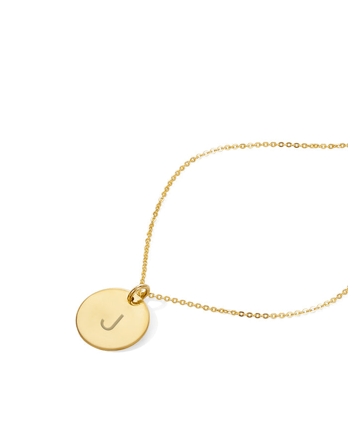 Gold disc pendant necklace with an initial