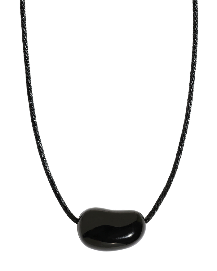 Black cord necklace with large polished black onyx bean-shaped pendant, white background