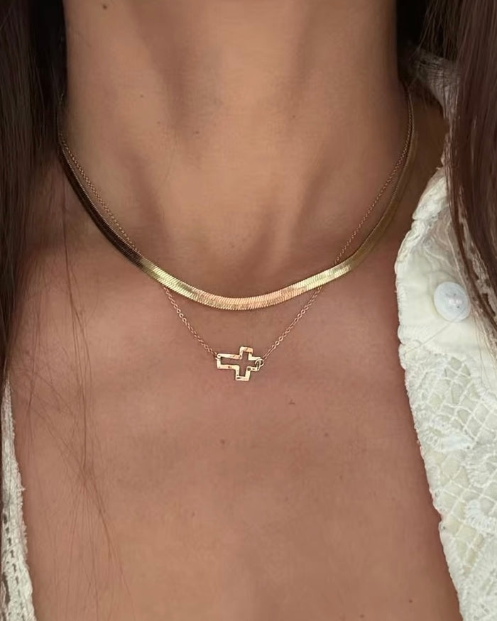 Delicate gold rolo chain necklace with tiny open cross pendant