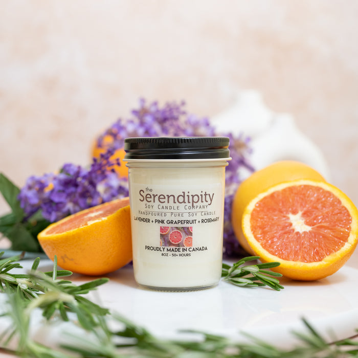 Serendipity scented candle with grapefruit, lavender and rosemary on a light background