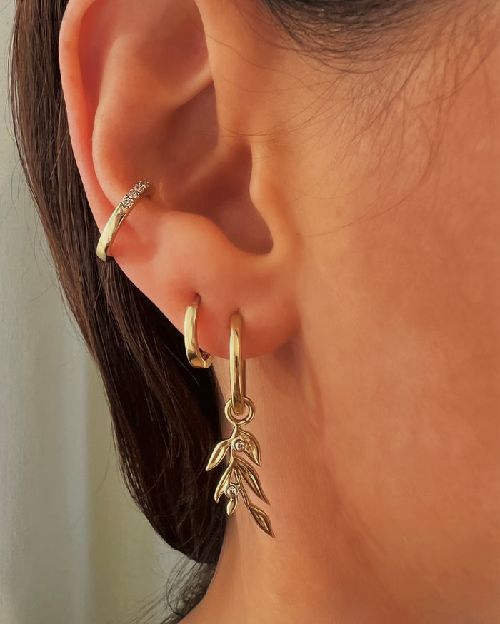Close-up of a woman's ear wearing an earring