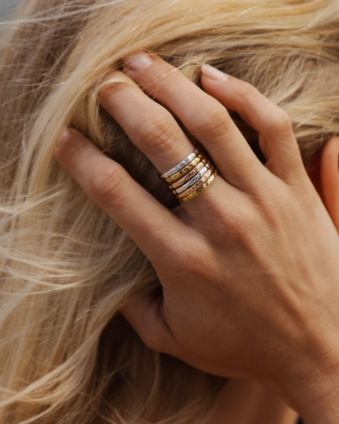 Set of gold stacking rings worn on a hand
