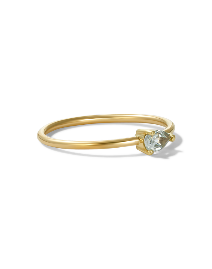 Gold ring with a green pear-cut stone