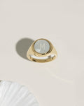 Gold signet ring with mother-of-pearl initial disc, product photo