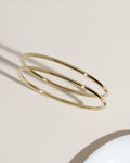 Two thin gold bangle bracelets