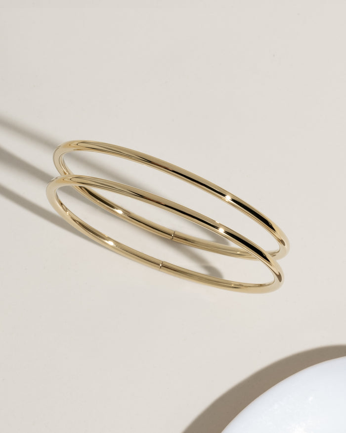 Two thin gold bangle bracelets